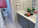 Beautiful bathroom featuring dual sinks, gray cabinets, and modern fixtures and plenty of counter space at 6511 Dove Point Pl, Las Vegas, NV 89130