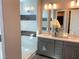 Elegant bathroom featuring double vanity, modern fixtures, and glass-enclosed shower at 6511 Dove Point Pl, Las Vegas, NV 89130
