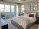 Serene bedroom with a plush bed, balcony access, and modern artwork for a peaceful retreat at 6511 Dove Point Pl, Las Vegas, NV 89130