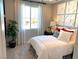 Inviting bedroom with soft, neutral colors and large window that provides plenty of natural light at 6511 Dove Point Pl, Las Vegas, NV 89130