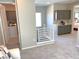 Spacious hallway with neutral tones, a stylish railing, and convenient built-in storage cabinets at 6511 Dove Point Pl, Las Vegas, NV 89130