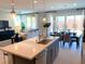 Open-concept kitchen and living area with an island, stainless steel appliances, and a seamless flow for entertaining at 6511 Dove Point Pl, Las Vegas, NV 89130