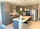 Modern kitchen with sleek gray cabinets, stainless steel appliances, and a spacious island, perfect for cooking and gathering at 6511 Dove Point Pl, Las Vegas, NV 89130