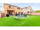Backyard featuring a well-manicured artificial lawn, seating and a cozy area with fire pit at 6624 Jade Jaguar St, North Las Vegas, NV 89086