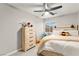 Bright bedroom with a white bed frame, wood dresser, and a window with blinds at 6624 Jade Jaguar St, North Las Vegas, NV 89086