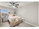 Cozy bedroom with a white bed frame, neutral walls and carpet, and a window with blinds at 6624 Jade Jaguar St, North Las Vegas, NV 89086