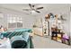 This bedroom features a ceiling fan, window, and shelving providing plenty of storage at 6624 Jade Jaguar St, North Las Vegas, NV 89086