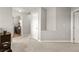 Hallway with doors to a laundry room and other rooms, featuring neutral carpeting and paint at 6624 Jade Jaguar St, North Las Vegas, NV 89086