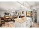 Spacious kitchen with a large island and stainless steel refrigerator connecting to dining and living areas at 6624 Jade Jaguar St, North Las Vegas, NV 89086