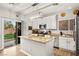 Bright kitchen with stainless steel appliances, island, granite countertop and sliding door to yard at 6624 Jade Jaguar St, North Las Vegas, NV 89086