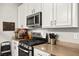 Close up of the kitchen with stainless steel oven, cook top, microwave and white cabinets at 6624 Jade Jaguar St, North Las Vegas, NV 89086