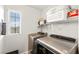 Convenient laundry room with modern appliances, shelving, and a window for natural light at 6624 Jade Jaguar St, North Las Vegas, NV 89086