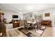 Open floor plan featuring dining and living area with wood-look flooring and neutral paint at 6624 Jade Jaguar St, North Las Vegas, NV 89086