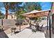 Delightful backyard patio area with comfortable seating under a charming pergola, surrounded by desert landscaping at 688 Castlebridge Ave, Las Vegas, NV 89123