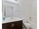 A clean and bright bathroom features a combination tub/shower, and vanity with dark cabinets at 688 Castlebridge Ave, Las Vegas, NV 89123