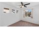 Bright bedroom features neutral tones, ceiling fan and multiple windows letting in natural light at 688 Castlebridge Ave, Las Vegas, NV 89123