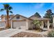 Charming single-Gathering home featuring desert landscaping, a two-car garage, and a welcoming front porch at 688 Castlebridge Ave, Las Vegas, NV 89123