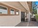 Inviting front porch featuring a secure iron gate, a decorative flower pot, and a well-lit entryway at 688 Castlebridge Ave, Las Vegas, NV 89123