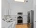 Clean kitchen featuring white cabinets, stainless steel appliances, tile flooring, and lots of natural light at 688 Castlebridge Ave, Las Vegas, NV 89123