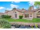 View of the home's backyard featuring a rock pond, a manicured lawn, and mature landscaping at 6940 Emerald Springs Ln, Las Vegas, NV 89113