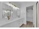 Modern bathroom featuring double sinks, marble countertops, and luxurious fixtures, plus a soaking tub at 6940 Emerald Springs Ln, Las Vegas, NV 89113