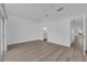 Spacious bedroom with tile flooring, vaulted ceilings, and attached bathroom with updated fixtures at 6940 Emerald Springs Ln, Las Vegas, NV 89113
