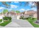 Charming exterior of home features manicured landscaping, driveway, and terracotta roof at 6940 Emerald Springs Ln, Las Vegas, NV 89113