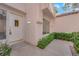 Close up of front door with tiled roof and small garden to side at 6940 Emerald Springs Ln, Las Vegas, NV 89113