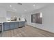 This eat-in kitchen features stainless steel appliances and blue cabinets under recessed lighting at 6940 Emerald Springs Ln, Las Vegas, NV 89113