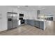Updated kitchen boasts stainless appliances, stone countertops, and two-tone cabinetry at 6940 Emerald Springs Ln, Las Vegas, NV 89113