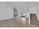 Bright living room has a modern fireplace, stairs, and wood floors at 6940 Emerald Springs Ln, Las Vegas, NV 89113