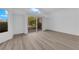 Open living space with large sliding doors leading to an outdoor area and neighborhood views at 6940 Emerald Springs Ln, Las Vegas, NV 89113