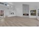 Bright living room features modern fireplace, wood floors, and open concept layout at 6940 Emerald Springs Ln, Las Vegas, NV 89113