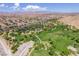 Expansive aerial view of the community park, showcasing the green spaces, walking trails, and surrounding neighborhood at 7715 Peaceful Trellis Dr, Las Vegas, NV 89179