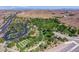 Beautiful aerial view of the community park with lush landscaping, parking, walking paths, and recreation areas at 7715 Peaceful Trellis Dr, Las Vegas, NV 89179