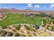 Scenic aerial view featuring green sports field, picnic shelters and desert mountain backdrop at 7715 Peaceful Trellis Dr, Las Vegas, NV 89179