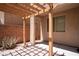 Inviting outdoor patio area with a wooden pergola and brick walls at 7715 Peaceful Trellis Dr, Las Vegas, NV 89179