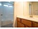 Cozy bathroom includes shower and tub combination with light wooden vanity at 7715 Peaceful Trellis Dr, Las Vegas, NV 89179