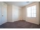 Inviting carpeted bedroom with natural light, neutral walls, and closet with double doors at 7715 Peaceful Trellis Dr, Las Vegas, NV 89179