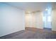 Spacious bedroom with carpet flooring, white walls, and a walk-in closet for storage at 7715 Peaceful Trellis Dr, Las Vegas, NV 89179