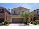 Two-story home features a cozy two-car garage and manicured landscaping at 7715 Peaceful Trellis Dr, Las Vegas, NV 89179