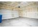 Spacious two-car garage with a white door, offering ample storage and parking space at 7715 Peaceful Trellis Dr, Las Vegas, NV 89179