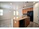 Bright kitchen features wood-style floors, modern lighting, and a breakfast bar at 7715 Peaceful Trellis Dr, Las Vegas, NV 89179