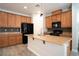 Open kitchen with wooden cabinets, granite countertops, and stylish backsplash at 7715 Peaceful Trellis Dr, Las Vegas, NV 89179