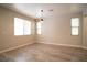 Bright living room with hardwood floors, neutral walls, and natural light from the windows with wooden blinds at 7715 Peaceful Trellis Dr, Las Vegas, NV 89179