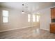Open living area with modern lighting, hardwood floors, and lots of natural light at 7715 Peaceful Trellis Dr, Las Vegas, NV 89179