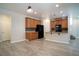 Open living room and kitchen feature wood floors, modern light fixtures at 7715 Peaceful Trellis Dr, Las Vegas, NV 89179