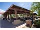 Covered picnic area with numerous tables and seating for outdoor gatherings and events at 7715 Peaceful Trellis Dr, Las Vegas, NV 89179