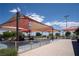 Fenced-in playground area with colorful shade canopies and various play structures at 7715 Peaceful Trellis Dr, Las Vegas, NV 89179