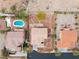 Overhead view of the home, neighbors, and pool featuring a spacious desert-landscaped lot and tile roof at 7756 River Mist Ct, Las Vegas, NV 89113